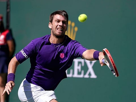 Cameron Norrie, of Britain, returns to Diego Schwartzman, of Argentina, at the BNP Paribas Open tennis tournament in Indian Wells, Calif. Norrie won the match.