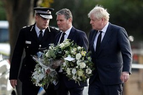 Chief Constable of Essex Police B. J. Harrington, Britain's Labour Party leader Keir Starmer and Prime Minister Boris Johnson arrive to pay tribute at the scene where British MP David Amess was stabbed to death during a meeting with constituents at the Belfairs Methodist Church, in Leigh-on-Sea, Britain, October 16, 2021.