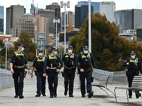 Police patrol the quiet streets of Melbourne on October 4, 2021.