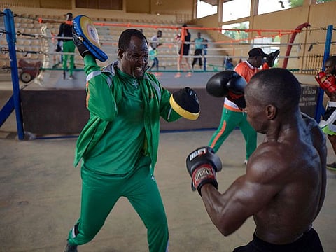 Coach Aziz Ousseini Doka training one of his students in the municipal stadium of Niamey, Niger