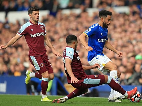 West Ham United's Algerian midfielder Said Benrahma (centre) slides in to tackle Everton's English striker Andros Townsend (right) during the English Premier League match at Goodison Park in Liverpool, north west England.