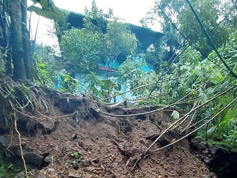 The collapsed portion of the compound wall in the house of Dubai-based Indian expat Rani Mariamma at Seethathode, Kerala.