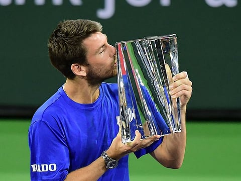 Cameron Norrie of Great Britain kisses the winner's trophy after victory over Nikoloz Basilashvili of Georgia in their men's final match at the Indian Wells tennis tournament on October 17, 2021 in Indian Wells, California.