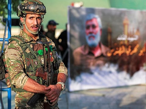 A member of Iraq's Hashd Al Shaabi (Popular Mobilisation Units) paramilitary forces stands guard during an election rally for the "Asaib Ahl Al Haq" movement in Baghdad.