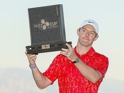 Rory McIlroy of Northern Ireland celebrates with the trophy after winning the final round of THE CJ CUP @ SUMMIT at The Summit Club on October 17, 2021 in Las Vegas, Nevada.