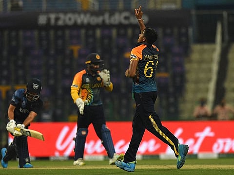 Sri Lanka's Maheesh Theekshana celebrates taking the wicket of Namibia's Jan Frylinck in Abu Dhabi