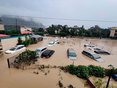Submerged cars are seen at a flooded hotel resort as extreme rainfall caused the Kosi River overflow at the Jim Corbett National Park in Uttarakhand, on October 19, 2021.