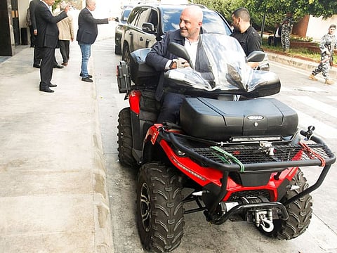 Pierre BouAssi, a member of the Lebanese Parliament arrives on a quad bike to attend a parliamentary session at UNESCO Palace in Beirut, Lebanon October 19, 2021.