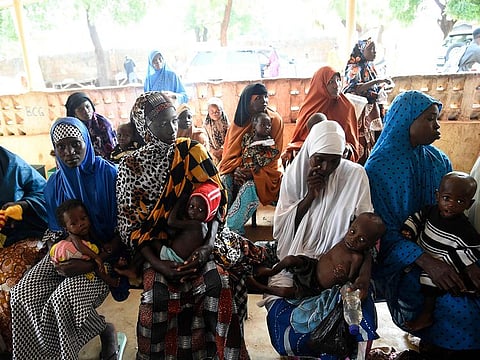 File photo: Mothers with acute malnurished babies sit waiting for medical attendtion at primary health clinic, Glgwai Sokoto North in northwest Nigeria, on September 21, 2021.