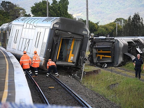 A derailed passenger train is seen after it hit a car on a level crossing in Kembla Grange, Australia, on October 20, 2021.