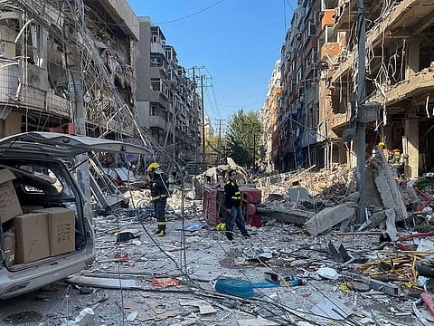 In this photo released by Xinhua News Agency, policemen and firefighters walk through damaged shophouses following a gas explosion in Shenyang in northeastern China's Liaoning Province, Thursday, Oct. 21, 2021.
