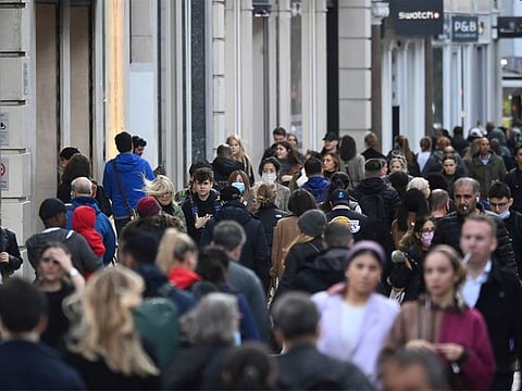 Shoppers, some wearing masks, walk along Oxford Street, in London, on October 20, 2021.