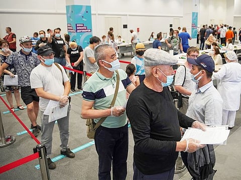 People wait to receive a COVID-19 vaccine at a vaccination centre in Luzhniki Stadium in Moscow.