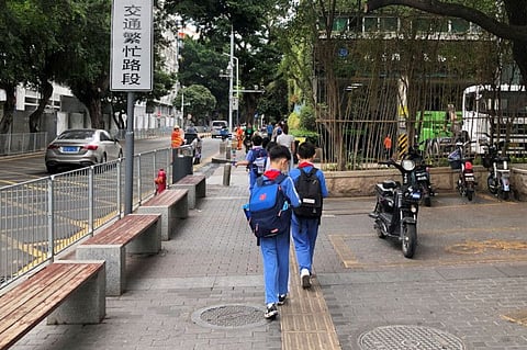 Children leave a school in Shekou area of Shenzhen, Guangdong province, China in a file photo. The government has imposed several rules in recent months aimed at combating activities it considers harmful to the development of China’s youth.