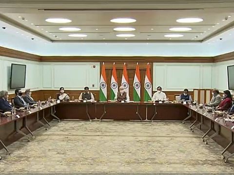 Prime Minister Narendra Modi with Health Minister Mansukh Mandaviya and other officials during a meeting with COVID-19 vaccine makers, in New Delhi, on October 23, 2021.