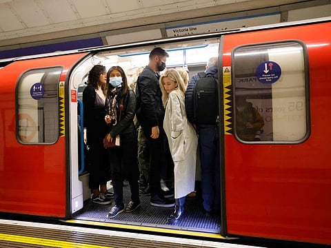 People travel in a packed London Underground tube train in London on October 23, 2021. The reported needle spiking incidents come after two high-profile murders of women on the streets, which have left Britain stunned.