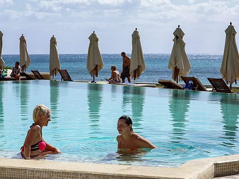 Tourists in a swimming pool at a hotel in Tunisia's resort town of Hammamet, about 66km south of the capital Tunis, on October 7, 2021.