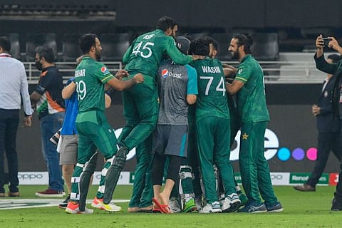 Pakistan's team members celebrate their victory at the end of the ICC mens Twenty20 World Cup cricket match against India t the Dubai International Cricket Stadium in Dubai, UAE.