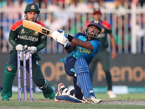 Sri Lanka's Charith Asalanka hits a boundary during the Cricket Twenty20 World Cup match against Bangladesh in Sharjah, UAE, on October 24, 2021.