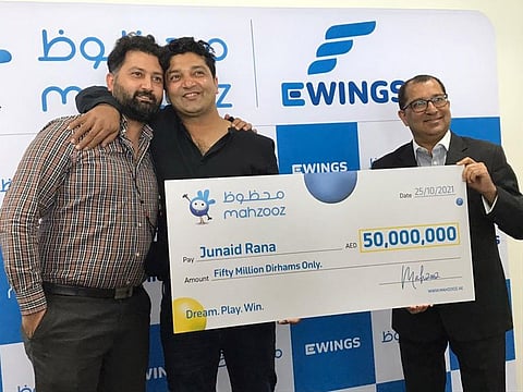 Junaid Rana, 36, from Pakistan (middle), is the winner of the Dh50 million grand prize from Mahzooz, said to be the biggest prize in the Middle East. Seen here on Monday with his brother Yaser (left) and Farid Samji (right), CEO of Ewings LLC, operator of Mahzooz.