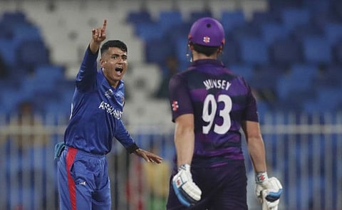 Afghanistan's Mujeeb Ur Rahman appeals successfully against Scotland's Richie Berrington during the Cricket Twenty20 World Cup match with Scotland in Sharjah, UAE, on October 25, 2021.