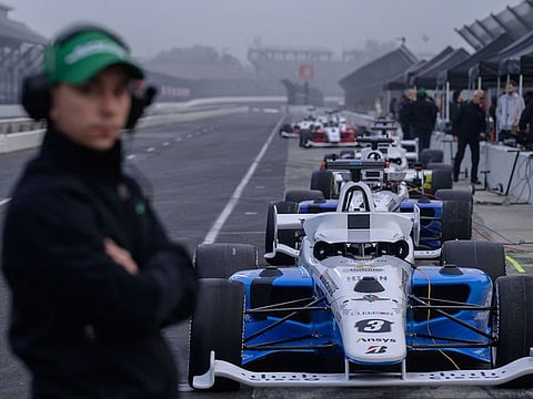 Cars are lined up on the grid during a practice session of the Indy Autonomous Challenge race.
