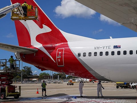 Aircraft appearance crew members clean an aircraft as Qantas begins preparing and equipping planes for the return of international flights at Sydney Airport on October 21, 2021.