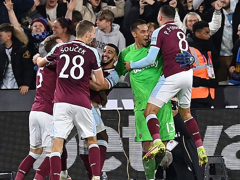 West Ham United’s Algerian midfielder Said Benrahma (C) celebrates with teammates after scoring the winning penalty.