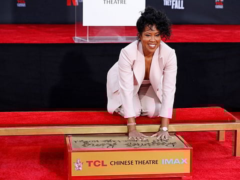 Regina King places her handprints in cement during a ceremony in the forecourt of the TCL Chinese theatre in Los Angeles, California on October 28, 2021.