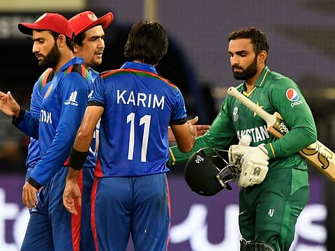 Pakistan's Asif Ali (right) shakes hands with Afghanistan's players at the end of the ICC men’s Twenty20 World Cup cricket match between Afghanistan and Pakistan at the Dubai International Cricket Stadium in Dubai.