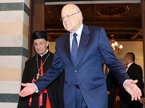 Lebanese Prime Minister Najib Mikati gestures meets with Maronite Patriarch Bechara Boutros Al Rai at the government palace in Beirut on October 26, 2021. Mikati, in a phone call with Kordahi on Friday evening, asked him to put the national interest first and “take the right decision to fix Arab relations with Lebanon,” a statement by his office said.