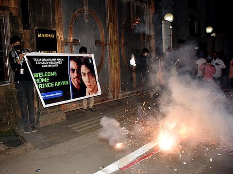 Bollywood actor Shah Rukh Khan fans celebrate outside his residence 'Mannat' after Bombay High Court granted bail to his son Aryan Khan in the drugs-on-cruise case