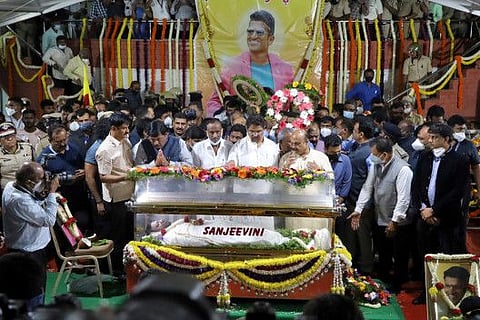 Basavaraj Bommai, Chief Minister of the southern state of Karnataka, Revenue Minister R. Ashok, Minister for Large and Medium-scale Industries Murugesh Nirani, and Minister of Science and Technology, Higher Education & IT, BT Dr. C.N. Ashwath Narayan, pay their respects next to the body of actor Puneeth Rajkumar (46) at the Sree Kanteerava Outdoor Stadium in Bengaluru