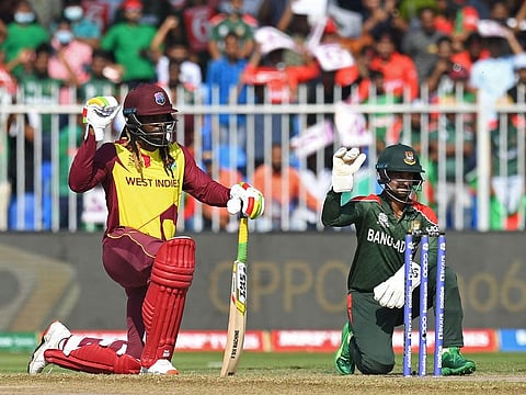 West Indies' Chris Gayle (left) and Bangladesh's wicketkeeper Liton Das kneel in support of the Black Lives Matter movement before the start of the ICC men’s Twenty20 World Cup cricket match at the Sharjah Cricket Stadium in Sharjah.