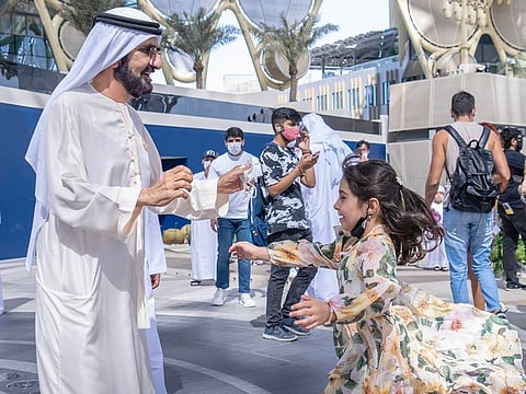 Sheikh Mohammed bin Rashid with young girl who wanted a photo with the Dubai Ruler