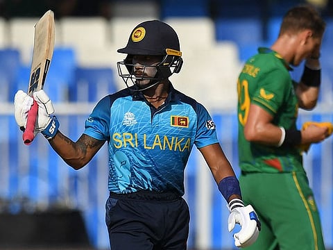 Sri Lanka's Pathum Nissanka celebrates after scoring a half-century during the ICC Men’s Twenty20 World Cup cricket match against South Africa at the Sharjah Cricket Stadium in Sharjah.