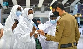 Saudi police member checks pilgrims for vaccination details on their smartphone in a file photo. The General Directorate of Prisons said that the visits are confined to prisoners’ first-degree relatives who have been fully vaccinated.
