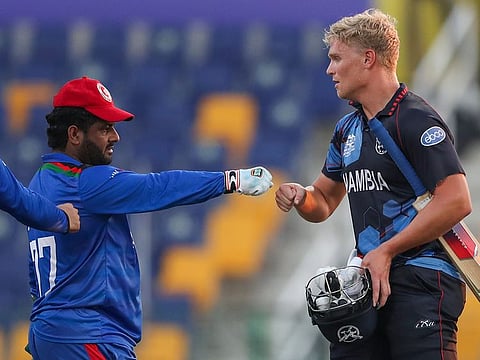Namibia's Ruben Trumpelmann congratulates Afghanistan's Mohammad Shahzad after Afghanistan defeated Namibia by 62 runs in their Cricket Twenty20 World Cup match in Abu Dhabi, UAE.