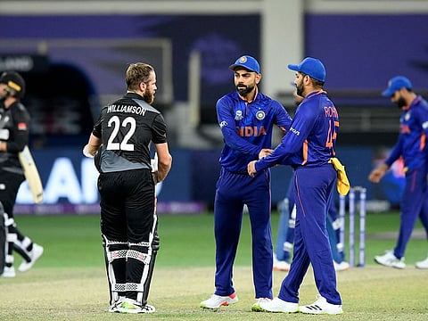 India's captain Virat Kohli along with his teammate Rohit Sharma greet New Zealand's captain Kane Williamson at the end of the ICC men’s Twenty20 World Cup cricket match at the Dubai International Cricket Stadium in Dubai, UAE.