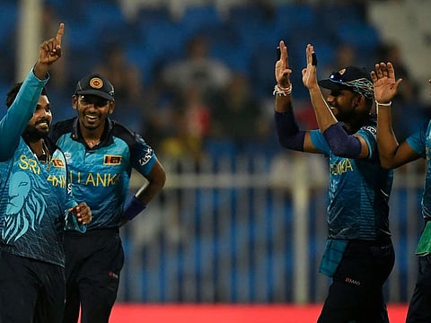 Wanindu Hasaranga (left) celebrates after taking the wicket of England's Jonny Bairstow in the last World T20 in UAE.