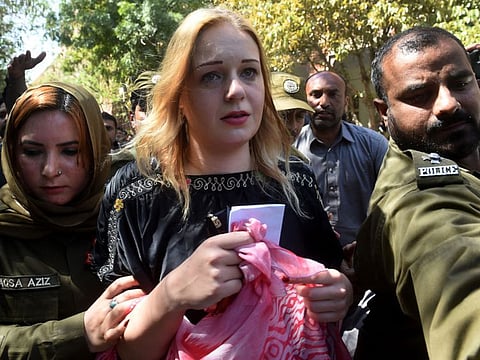 Police escort Czech model Tereza Hluskova after the court sentenced her to eight years and eight months in prison for allegedly trafficking heroin, in Lahore, on March 20, 2019.