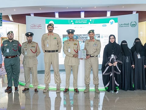 Dubai Police officials with the 100 per cent Paperless Stamp