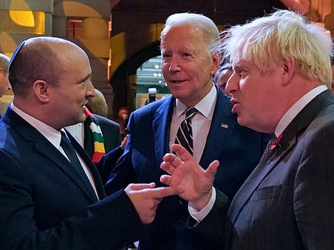 Israel's Prime Minister Naftali Bennett (left), US President Joe Biden (centre) and British Prime Minister Boris Johnson chat at a reception to mark the opening day of COP26 on the sidelines of the COP26 UN Climate Change Conference in Glasgow, Scotland, on November 1, 2021.