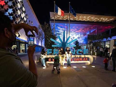Visitors click pictures in front of the popular France Pavilion