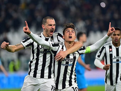 Juventus' Paulo Dybala celebrates scoring their second goal with Leonardo Bonucci.
