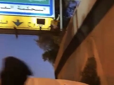 The man waves from the billboard.