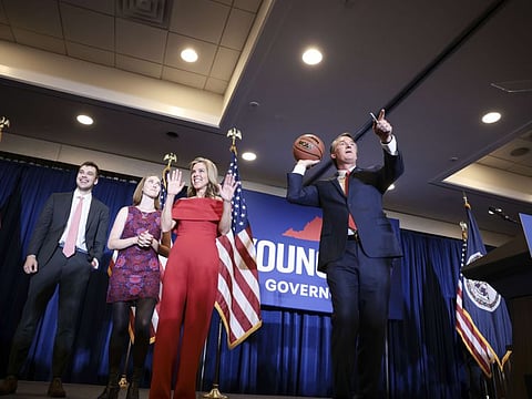 Virginia Republican gubernatorial candidate Glenn Youngkin passes an autographed basketball into the crowd with his family at his election night rally at the Westfields Marriott Washington Dulles on November 2, 2021 in Chantilly, Virginia.