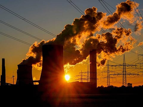 Steam comes out of the chimneys of the coal-fired power station in Niederaussem, Germany, Sunday, Oct. 24, 2021.