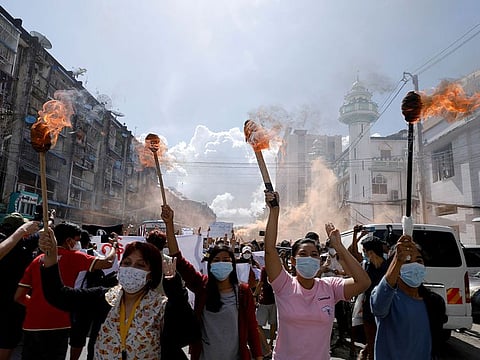 A group of women hold torches as they protest in Myanmar in this file shot