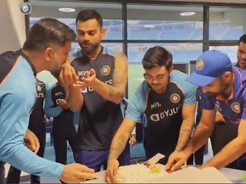 Virat Kohli takes part in his birthday celebrations with team mentor MS Dhoni (left), teammates Ishan Kishan and Mohammed Shami after their win over Scotland on Friday night.